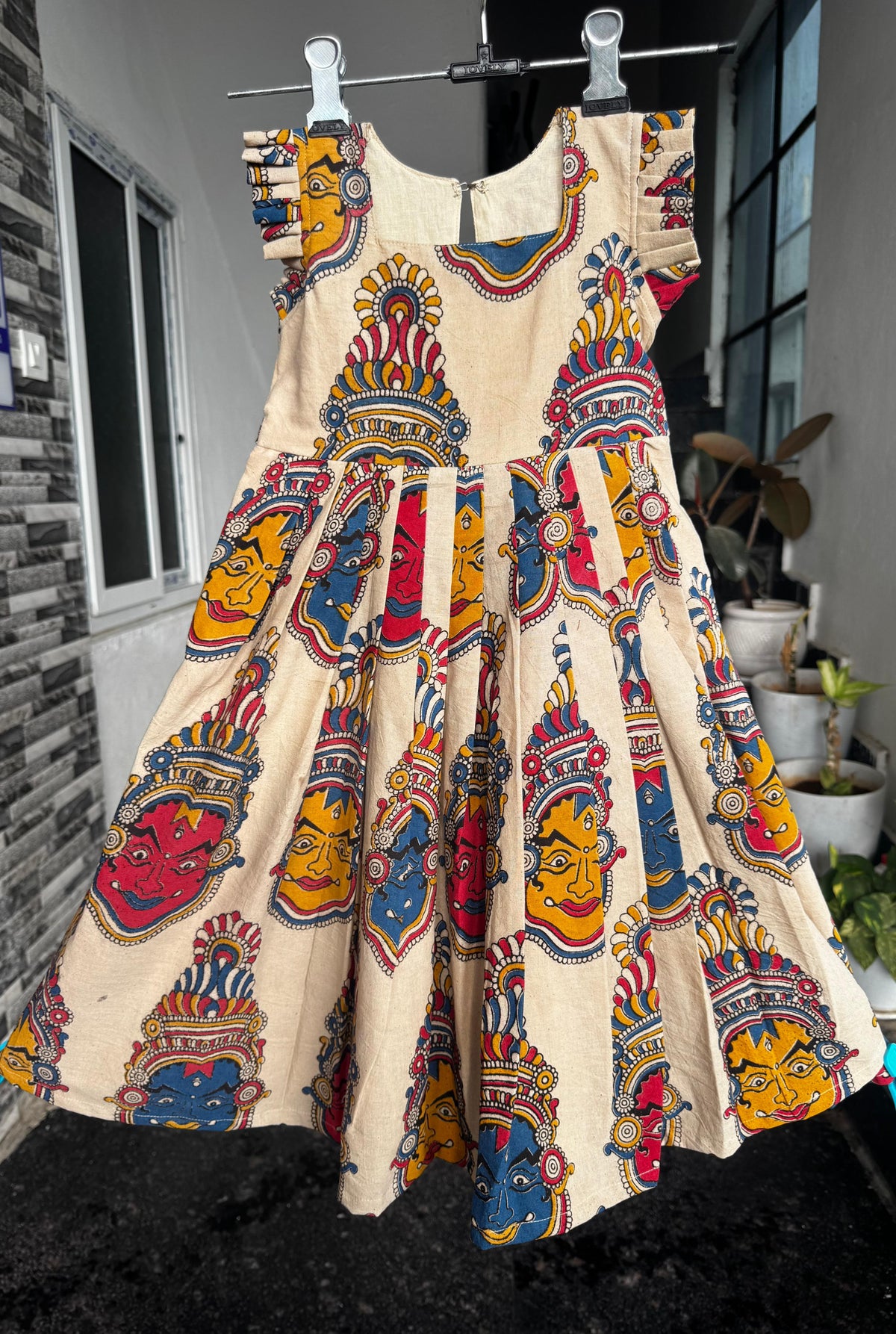 Kalamkari cotton kids frock in cream with multicolour traditional-inspired print and ruffle sleeves